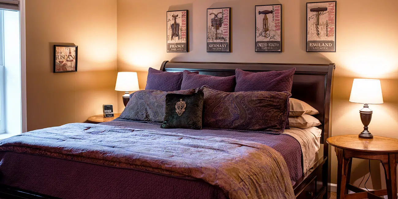guest room with purple bedspread